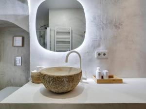 a bathroom with a large stone sink and a mirror at Casa Jasmin cosy 4 bedroom house with terrace in Hospitalet de Llobregat +68 photos