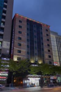 a tall building with lights on top of it at LEX Tourist Hotel in Seoul