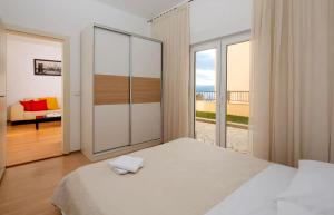a bedroom with a bed and a view of the ocean at Luxury apartment Roko in Omiš