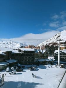a group of people in the snow in front of buildings at Val Thorens Studio 2 personnes et balcon Plein Sud in Val Thorens