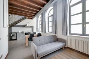 a living room with a couch and a table at Bigattera lofts - Affitti Brevi Italia in Varese