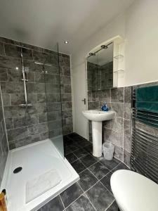 a bathroom with a shower and a sink and a toilet at Spacious Home w/ Parking & Garden in Worthing