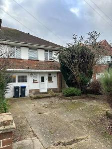 a brick house with a driveway in front of it at Spacious Home w/ Parking & Garden in Worthing