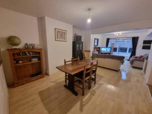 a living room with a table and a couch at Spacious Home w/ Parking & Garden in Worthing