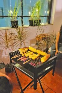 a grill with corn and corn sticks on it at Pearl - Sunflower Skyline in Bangalore