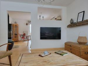 a living room with a flat screen tv on a wall at Sonnwies - Erholung pur im Bayerischen Wald in Perlesreut