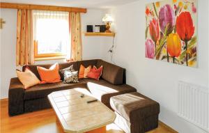 a living room with a couch and a table at Nice Apartment In Bruck Am Ziller With 1 Bedrooms in Bruck am Ziller