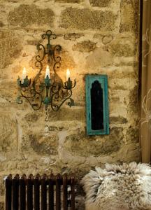 a stone wall with a chandelier and a window at Crab Lane Studios in Carlow