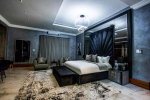 a bedroom with a king sized bed and a living room at Mekete Boutique & Events in Polokwane