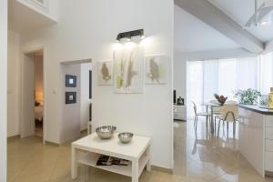 a kitchen and a living room with a table at Adorable Holiday House Lilla-with pool-near Old Town Labin in Labin