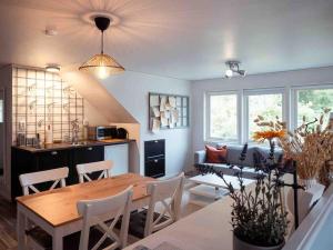 a dining room and living room with a table and chairs at A lovely bright apartment with it's own entrance in Kungsbacka