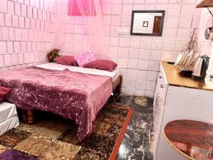 a small room with two beds in a kitchen at MDY Studio Room - Mysore in Mysore