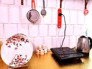 a counter top with a toaster and a scale on a table at MDY Studio Room - Mysore in Mysore