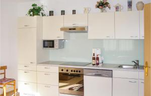 a white kitchen with white cabinets and a sink at Awesome Apartment In Trins With 1 Bedrooms And Wifi in Trins