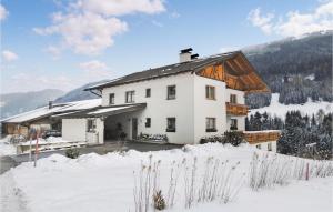 a white house in the snow with mountains in the background at Awesome Apartment In Trins With 1 Bedrooms And Wifi in Trins