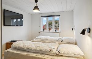 two beds in a room with a window at Nice Home In Faaborg With Wifi in Fåborg