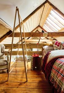 a attic room with a bed and a chair at Crab Lane Studios in Carlow