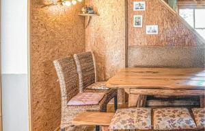 a dining room with a wooden table and chairs at Beautiful Home In Mayrhofen With 3 Bedrooms in Mayrhofen