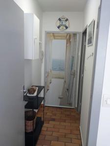 a hallway with a door leading to a room with the ocean at 2min mer Studio Parking Balcon Wifi Clim in Six-Fours-les-Plages
