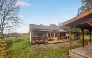 a house with a stone wall next to a yard at Gorgeous Home In Besmont With Wi-fi in Éparcy