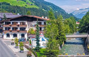 a building next to a river with a bridge at Amazing Apartment In Kirchberg With 1 Bedrooms in Kirchberg in Tirol