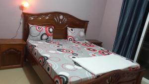 uma cama com cabeceira e almofadas de madeira em Peace N Quiet aux Almadies em Dakar