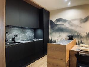 a kitchen with a mountain mural on the wall at Dolomiti Haus - Immerso nelle Dolomiti in Tesero