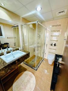 a bathroom with a shower and a sink and a toilet at Luxury Apartment Al Khan Corniche View 2 BD in Sharjah