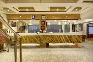 a lobby with a large counter in a building at Hotel Shanti Plaza-by Haveliya Hotels in New Delhi