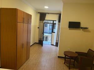 a living room with a cabinet and a table at Hotel 21 in Āksum