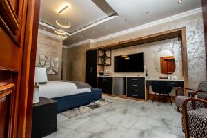 a hotel room with a king bed and a desk at Mekete Boutique & Events in Polokwane