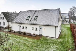 an aerial view of a white house with a metal roof at Charming House By The Baltic Sea in Bøtø By