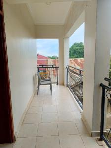 a balcony with a chair and a view at Twinkle Blue Inn in Namugongo