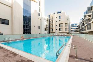 a large swimming pool in the middle of a building at Landing Lane Family Suites, Studio Near DXB Airport in Dubai