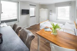 a living room with a table and a couch at Haus Delft Agadir in Juist