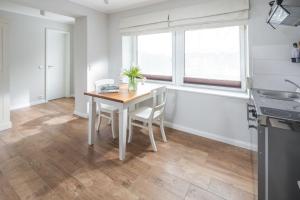 a kitchen with a table and chairs in a room at Haus Delft Minerva in Juist