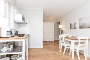 a kitchen and dining room with a table and chairs at Haus Delft Jakea in Juist