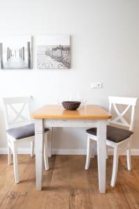 a dining room table with two chairs and a bowl on it at Haus Delft Anna in Juist