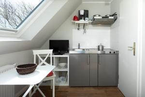 a small kitchen with a sink and a window at Haus Delft Ilmenau in Juist