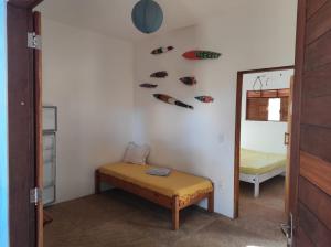 a room with a bench and shoes on the wall at Chalés Peixes & Tartarugas in São Miguel do Gostoso