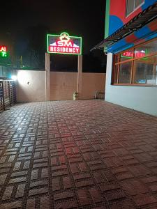 a restaurant with a sign on the side of a building at SM Residency in Coimbatore