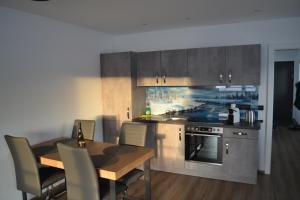a kitchen with a wooden table and a dining room at Apartment Ausblick in Tamsweg