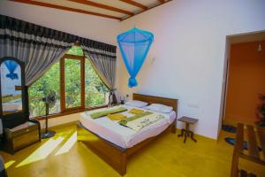 a bedroom with a bed with a blue balloon hanging from the wall at Nine Arch View Ella in Ella