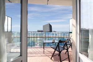 a balcony with a table and a view of the city at Magnifique 3 pièces Garibaldi in Nice