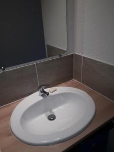 a white sink in a bathroom with a mirror at Studio 007 à Aix in Aix-en-Provence
