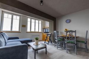a living room with a couch and a table at Flore in Saint-Aignan