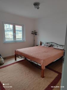 a bedroom with a bed in a room with a window at Wohnung mit Weitblick in Schwäbisch Hall