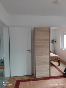 a sliding door in a room with a bedroom at Wohnung mit Weitblick in Schwäbisch Hall