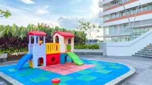 a toy play set on a tile floor in front of a building at Nuvasa Bay The Nove Kalani Tower in Telukmataikan