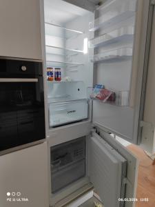 an empty refrigerator with its door open in a kitchen at Wohnung mit Weitblick in Schwäbisch Hall